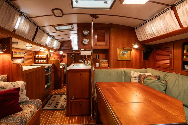 Slide: The Image of Luxurious 1989 Hinckley Sou'wester 51 yacht interior with wood finishes and cozy seating area. - 32