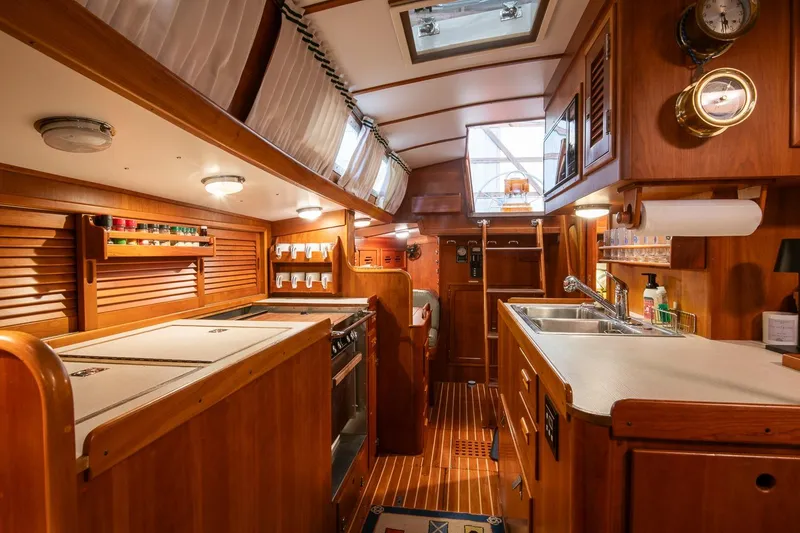 Slide: The Image of Luxurious 1989 Hinckley Sou'wester 51 yacht interior with wooden cabinetry and modern amenities. - 33