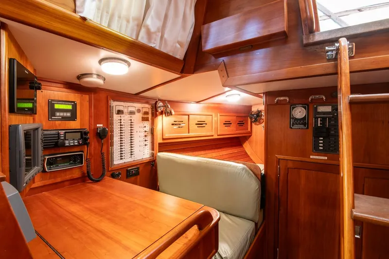 Slide: The Image of Interior of 1989 Hinckley Sou'wester 51 yacht with navigation equipment and wooden cabinetry. - 34