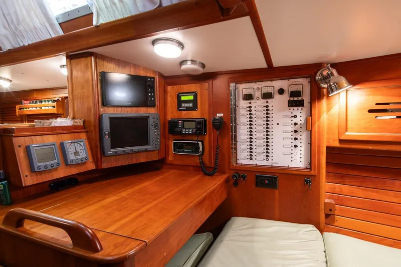 Slide: The Image of Navigation station of 1989 Hinckley Sou'wester 51 yacht with control panels and instruments. - 35
