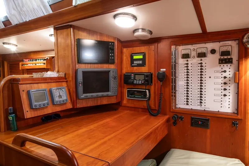 Slide: The Image of Navigation station of 1989 Hinckley Sou'wester 51 yacht with control panels and instruments. - 36