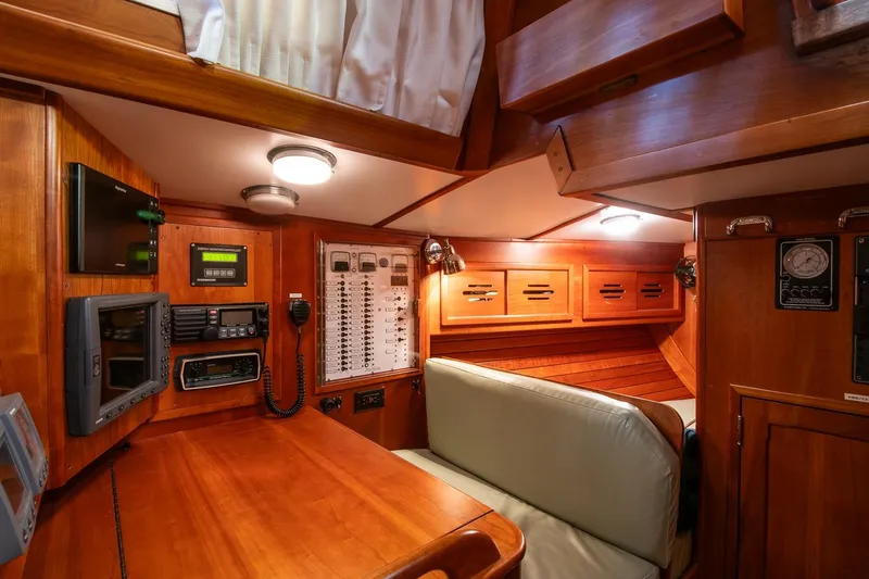 Slide: The Image of Interior of 1989 Hinckley Sou'wester 51 yacht with navigation equipment and wooden cabinetry. - 37