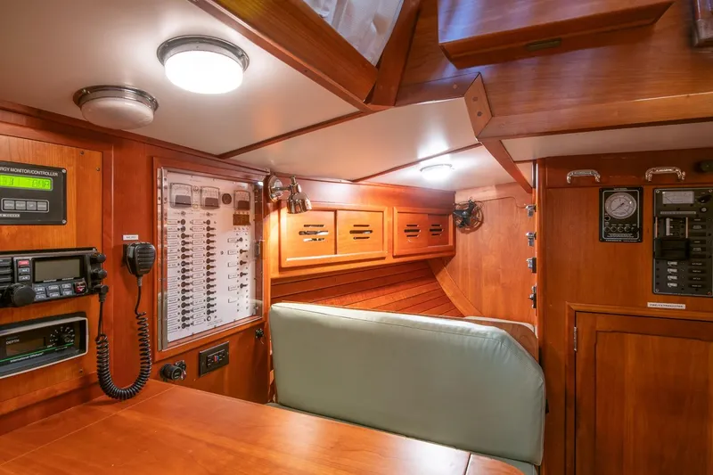 Slide: The Image of Interior of 1989 Hinckley Sou'wester 51 yacht with navigation equipment and wooden cabinetry. - 38