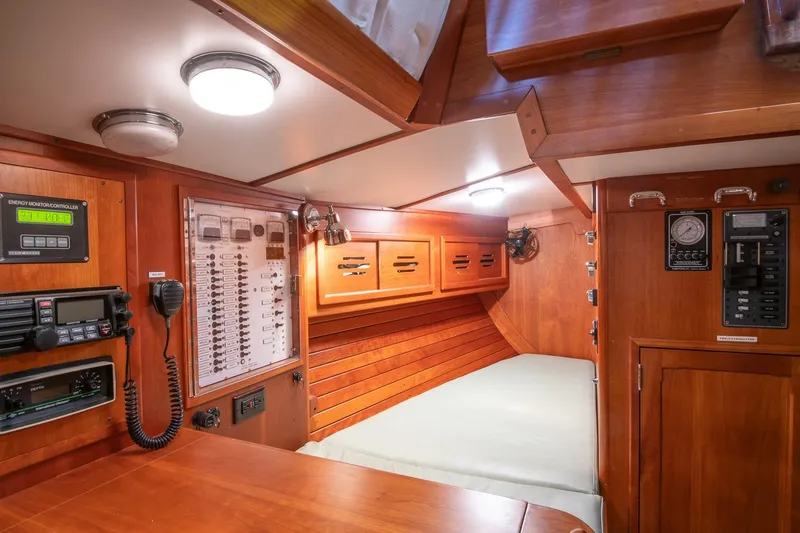 Slide: The Image of Interior of 1989 Hinckley Sou'wester 51 sailboat with wood paneling and navigation equipment. - 39