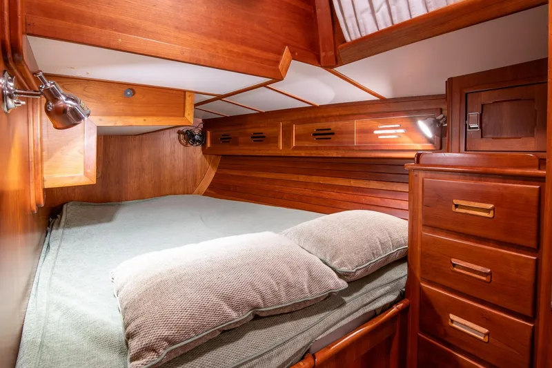 Slide: The Image of Cozy wooden cabin interior of 1989 Hinckley Sou'wester 51 sailboat with bed and storage. - 43