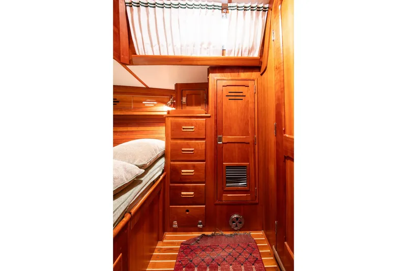 Slide: The Image of Cozy wooden cabin interior of 1989 Hinckley Sou'wester 51 sailboat with drawers and bed. - 46