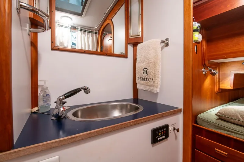 Slide: The Image of Hinckley Sou'wester 51 yacht bathroom with sink, mirror, and towel, 1989 model. - 48
