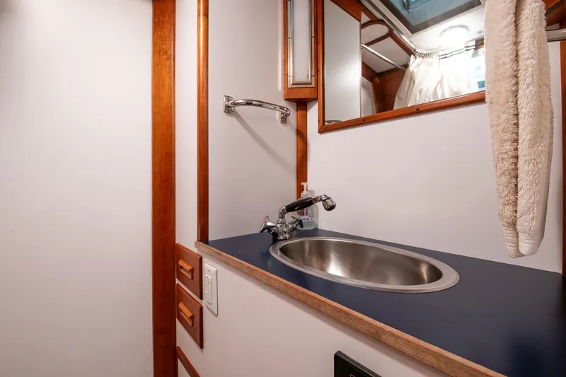 Slide: The Image of Hinckley Sou'wester 51 yacht bathroom with sink, mirror, and towel, 1989 model. - 49