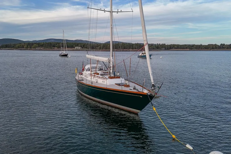 Slide: The Image of Sailboat Hinckley Sou'wester 51 (1989) anchored in scenic coastal waters. - 5