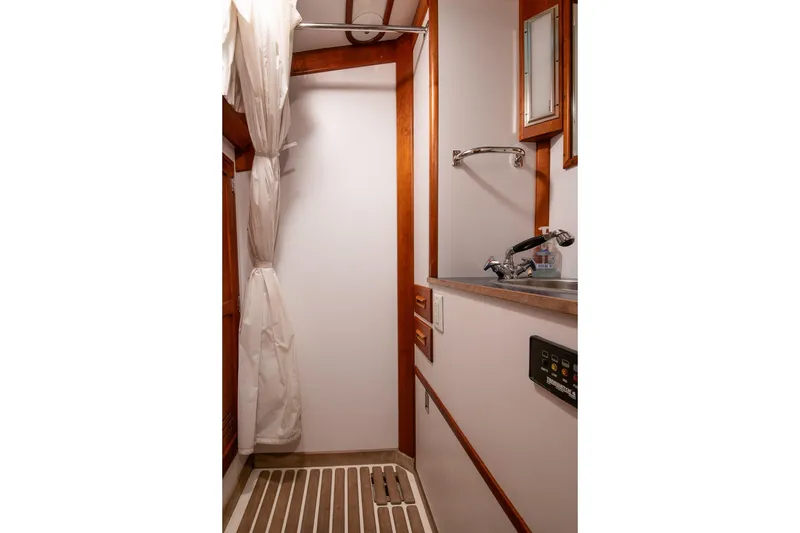 Slide: The Image of Hinckley Sou'wester 51 yacht bathroom, 1989 model, featuring wooden accents and compact design. - 50