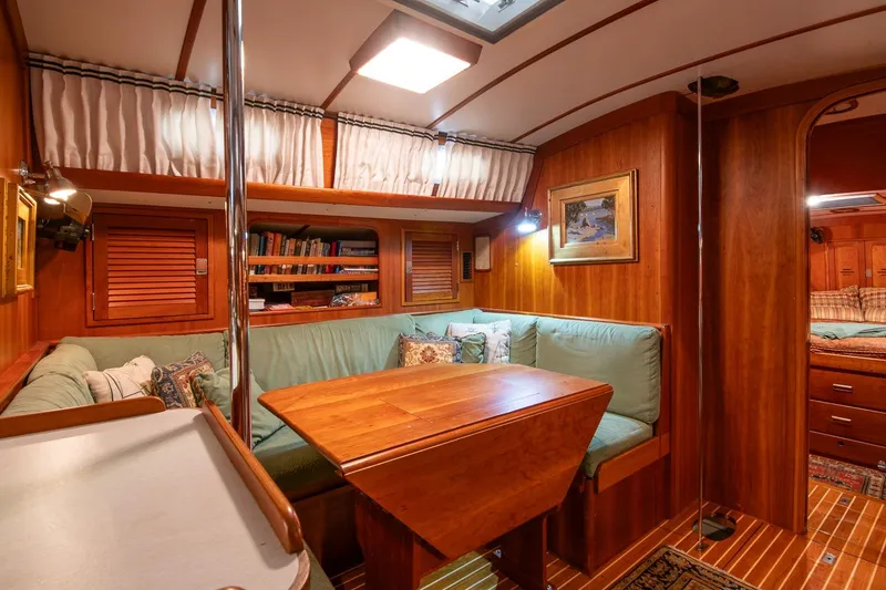 Slide: The Image of Cozy interior of 1989 Hinckley Sou'wester 51 yacht with wooden furnishings and seating area. - 54