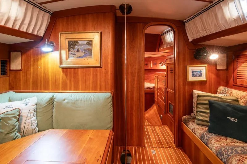 Slide: The Image of Luxurious 1989 Hinckley Sou'wester 51 yacht interior with elegant wood finish and cozy seating. - 58