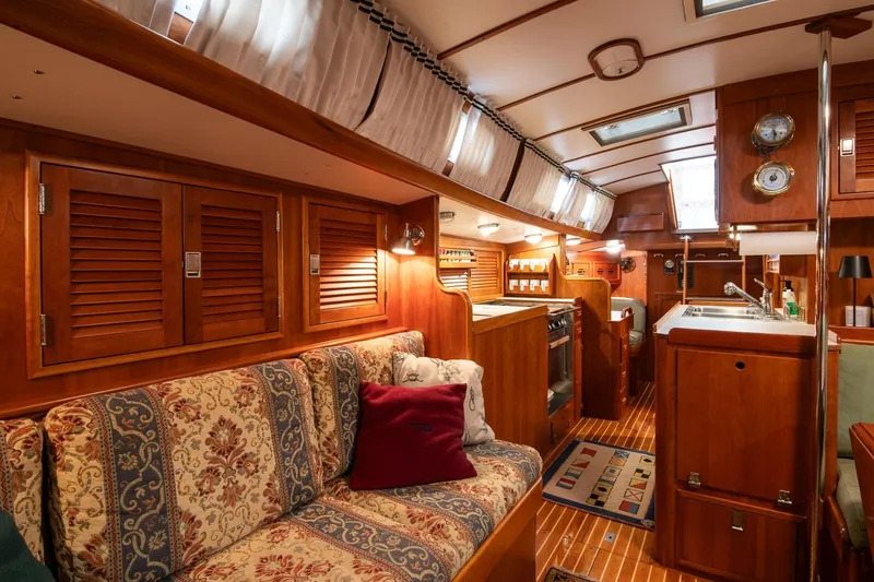 Slide: The Image of Luxurious interior of 1989 Hinckley Sou'wester 51 yacht with wood finishes and cozy seating. - 59