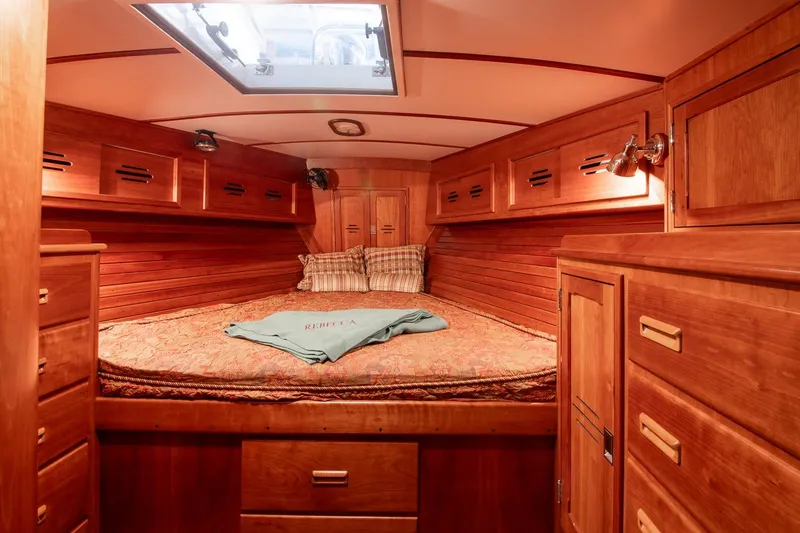 Slide: The Image of Luxurious wooden cabin interior of 1989 Hinckley Sou'wester 51 yacht, featuring cozy bedding. - 60