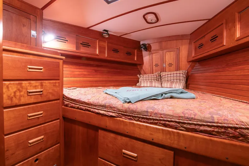 Slide: The Image of Luxurious wooden cabin interior of 1989 Hinckley Sou'wester 51 yacht with cozy bedding. - 61