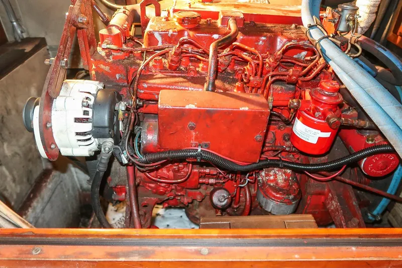 Slide: The Image of Engine compartment of a 1989 Hinckley Sou'wester 51 sailboat, featuring red mechanical components. - 68
