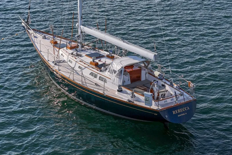 Slide: The Image of 1989 Hinckley Sou'wester 51 sailboat on water, named "Rebecca," with elegant design. - 9