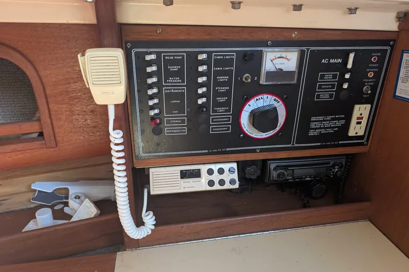 Slide: The Image of Electrical control panel on a 1986 CAL 28 sailboat, featuring switches and a microphone. - 5