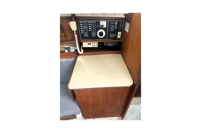 Slide: The Image of Control panel inside a 1986 CAL 28 sailboat, featuring communication equipment and switches. - 6