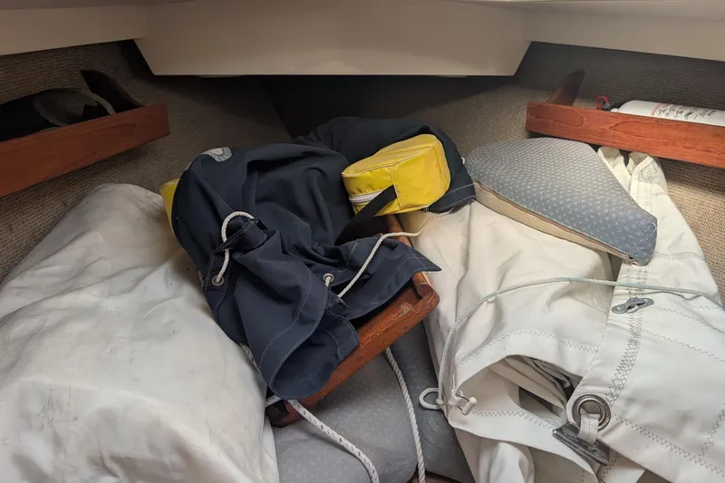 Slide: The Image of Interior of a 1986 CAL 28 sailboat with sailing gear and cushions. - 8