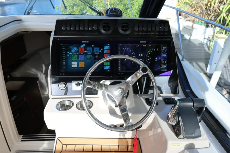 Slide: The Image of Helm of 2025 Boston Whaler 325 Conquest with advanced navigation display and controls. - 10