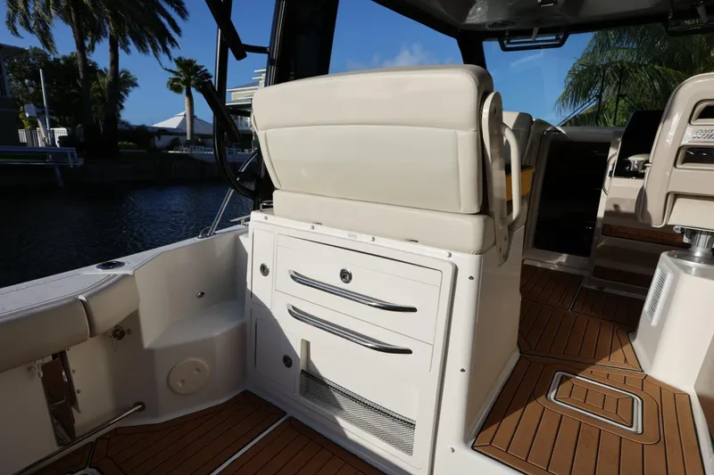 Slide: The Image of 2025 Boston Whaler 325 Conquest interior with seating and storage, featuring teak flooring. - 15