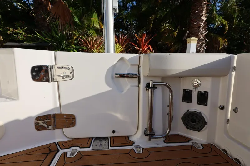 Slide: The Image of 2025 Boston Whaler 325 Conquest boat interior with teak flooring and stainless steel fittings. - 19