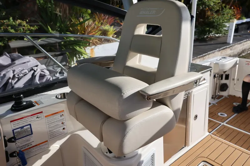 Slide: The Image of Captain's chair on 2025 Boston Whaler 325 Conquest boat, featuring luxurious design and comfort. - 20