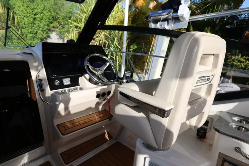 Slide: The Image of Helm of 2025 Boston Whaler 325 Conquest with modern controls and comfortable seating. - 21