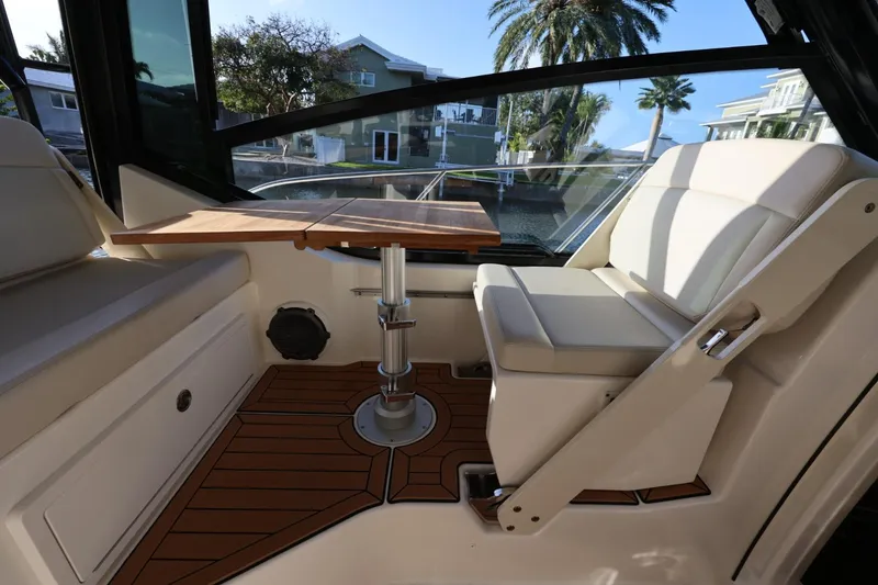 Slide: The Image of Interior of 2025 Boston Whaler 325 Conquest with seating and wooden table. - 23