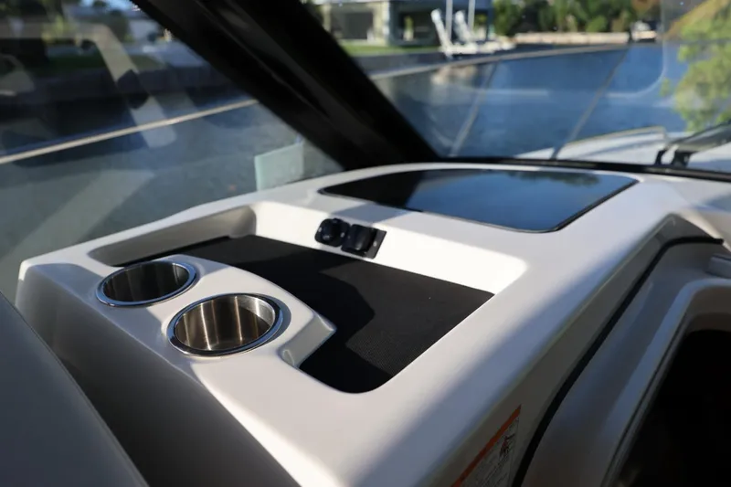 Slide: The Image of Dashboard of 2025 Boston Whaler 325 Conquest with cup holders and sleek design. - 25