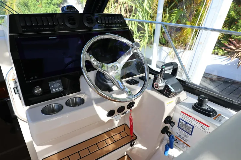 Slide: The Image of Helm of 2025 Boston Whaler 325 Conquest with modern controls and navigation system. - 26