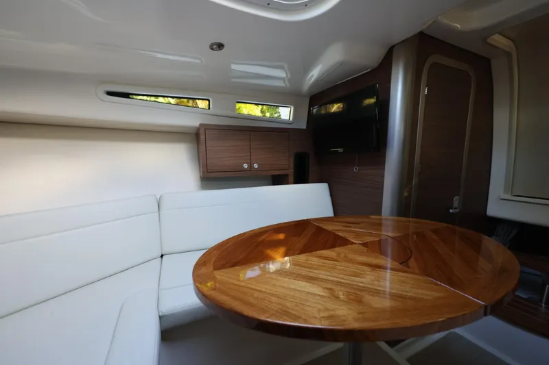 Slide: The Image of Luxurious interior of 2025 Boston Whaler 325 Conquest with elegant wood table and seating. - 29