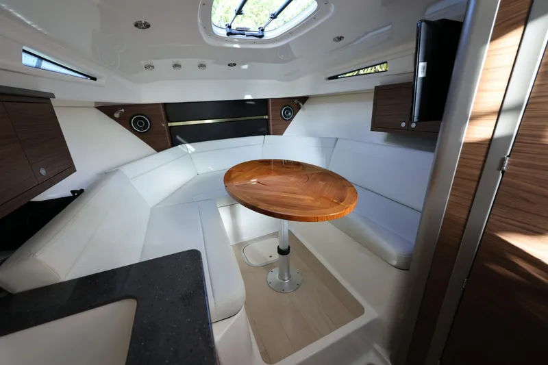 Slide: The Image of Luxurious interior of 2025 Boston Whaler 325 Conquest with elegant seating and wooden table. - 30