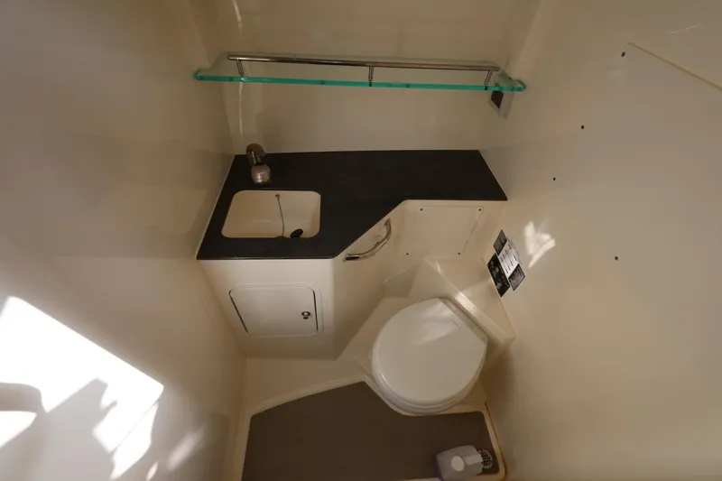 Slide: The Image of 2025 Boston Whaler 325 Conquest bathroom with sink, toilet, and storage. - 32