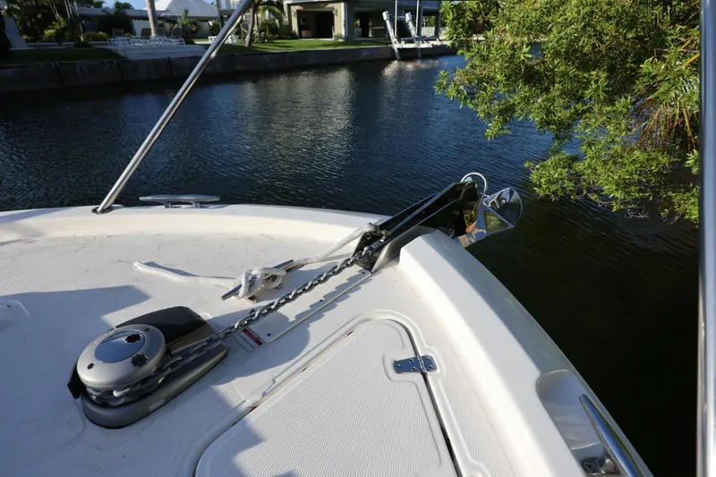 Slide: The Image of 2025 Boston Whaler 325 Conquest boat anchor system on calm water. - 36