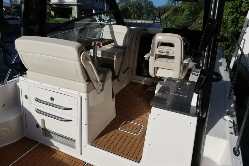 Slide: The Image of 2025 Boston Whaler 325 Conquest interior with seating and storage, featuring sleek design. - 39