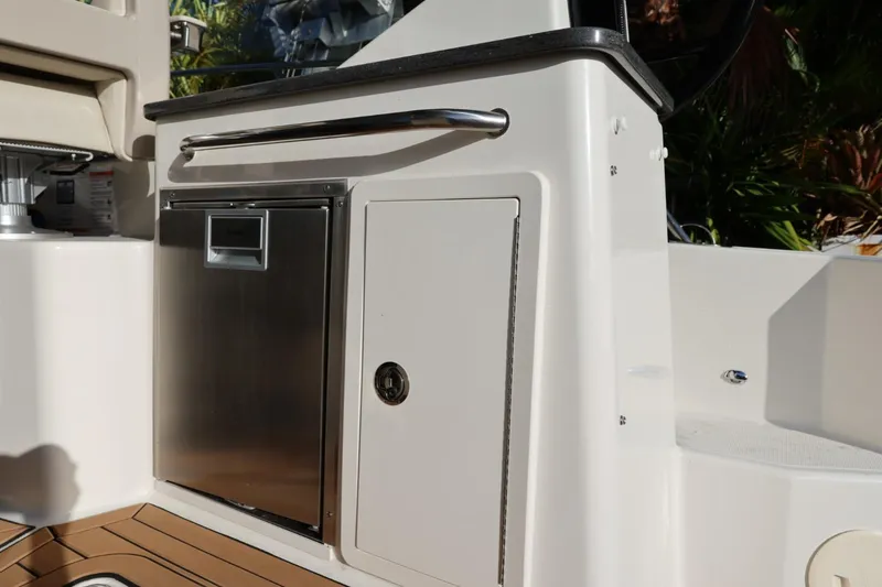 Slide: The Image of 2025 Boston Whaler 325 Conquest boat interior with stainless steel storage and seating. - 41