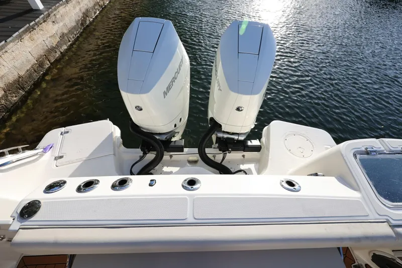 Slide: The Image of 2025 Boston Whaler 325 Conquest with dual Mercury outboard engines on water. - 8