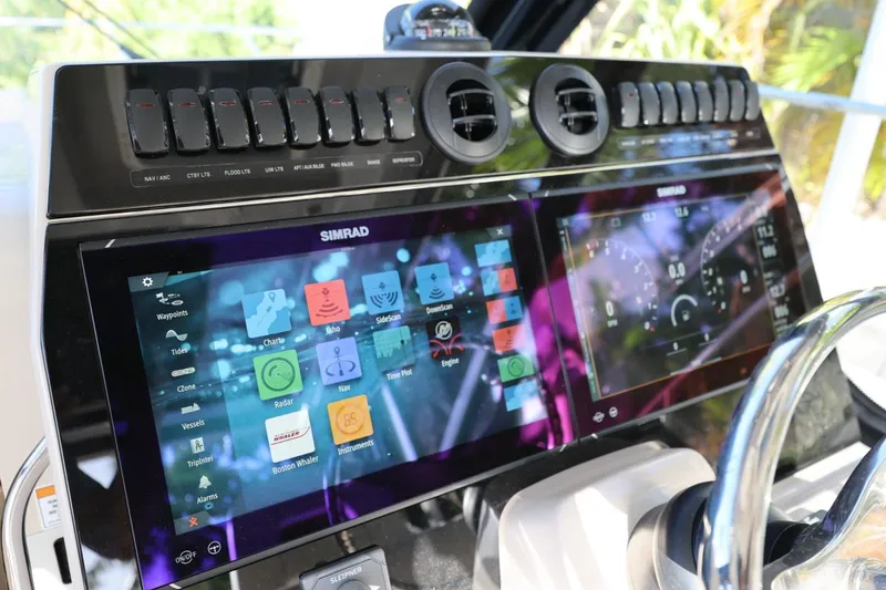 Slide: The Image of 2025 Boston Whaler 325 Conquest dashboard with advanced Simrad navigation system. - 9
