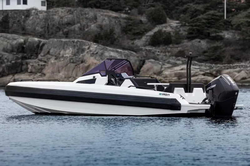Slide: The Image of Manufacturer Provided Image: Modern Iron 707 boat from 2025 on calm water, rocky shoreline in background. - 11