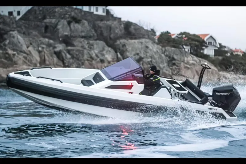 Slide: The Image of Manufacturer Provided Image: High-speed Iron 707 boat navigating rocky coastal waters, 2025 model. - 12