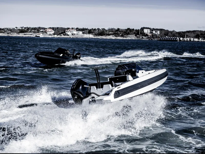Slide: The Image of Manufacturer Provided Image: Two Iron 707 boats navigating waves, showcasing speed and performance, 2025 model. - 14