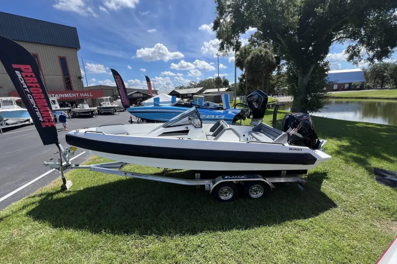 Slide: The Image of Iron 707 boat on trailer at outdoor event, 2026 model, sunny day. - 2