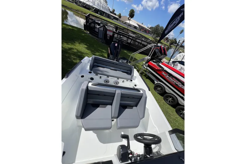 Slide: The Image of Modern Iron 707 boat interior, 2026 model, featuring sleek seating and steering wheel, displayed outdoors. - 7