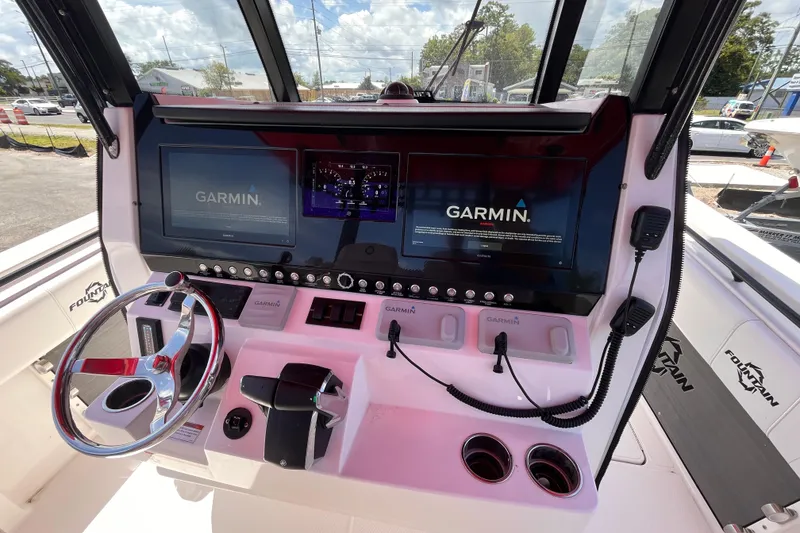 Slide: The Image of 2023 Fountain 38 Tournament Edition boat dashboard with Garmin navigation displays. - 11