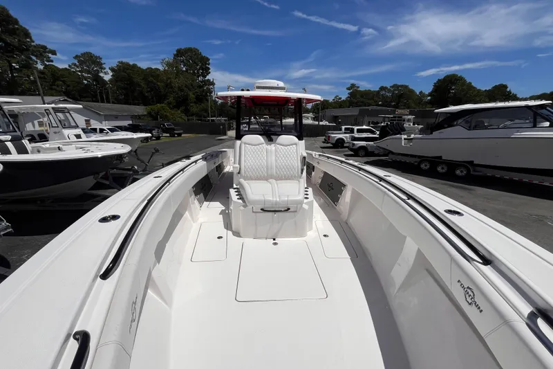 Slide: The Image of 2023 Fountain 38 Tournament Edition boat with sleek white interior and seating. - 17