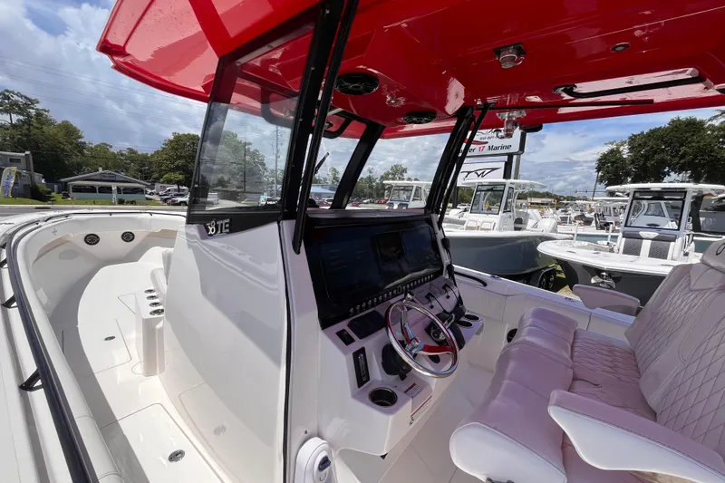 Slide: The Image of 2023 Fountain 38 Tournament Edition boat interior with red canopy and advanced control panel. - 21