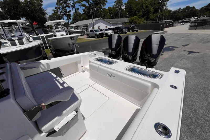 Slide: The Image of 2023 Fountain 38 Tournament Edition boat with triple outboard engines, docked at a marina. - 22