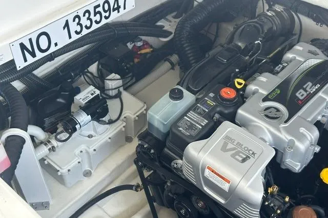 Slide: The Image of Engine compartment of 2023 Formula 350 Crossover Bowrider I/O with V8 engine components. - 12